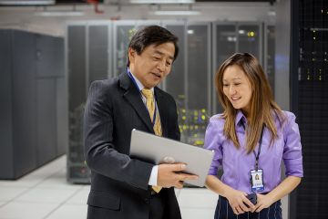 man and woman in data center