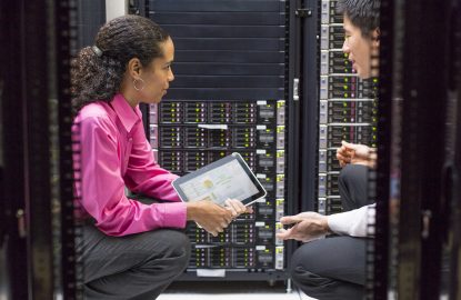 Man and woman having a conversation while working in a data center. data center