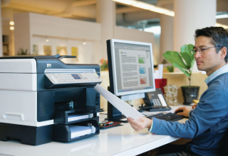 man looking at printer